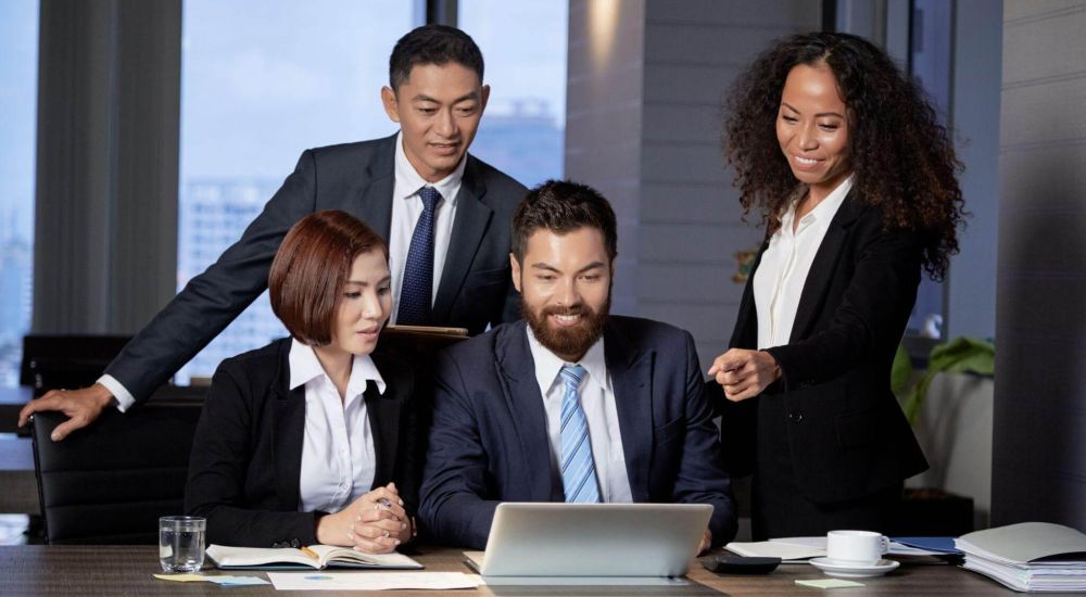 Business team reviewing laptop content