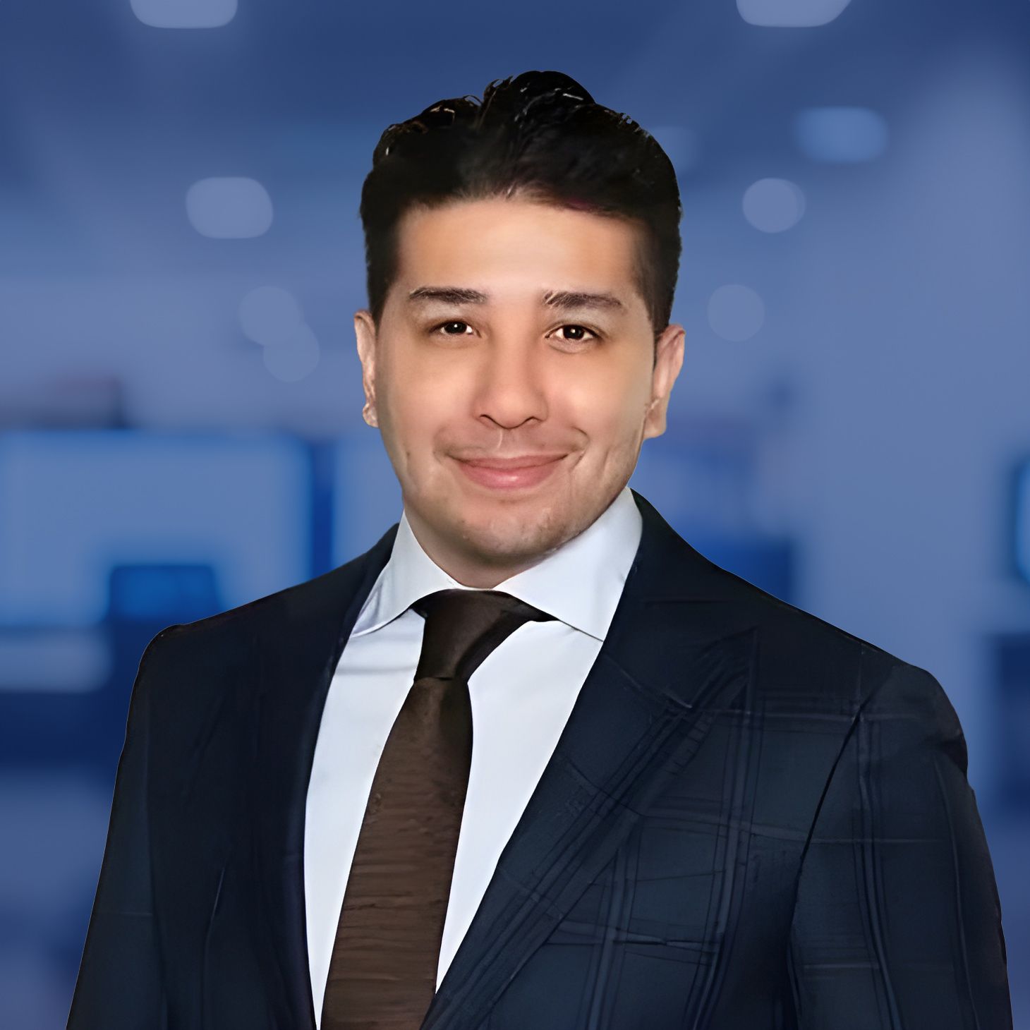 Professional man in suit smiling confidently in a modern office setting.