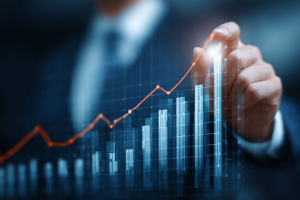 Businessman analyzing financial growth graph with rising bar chart.