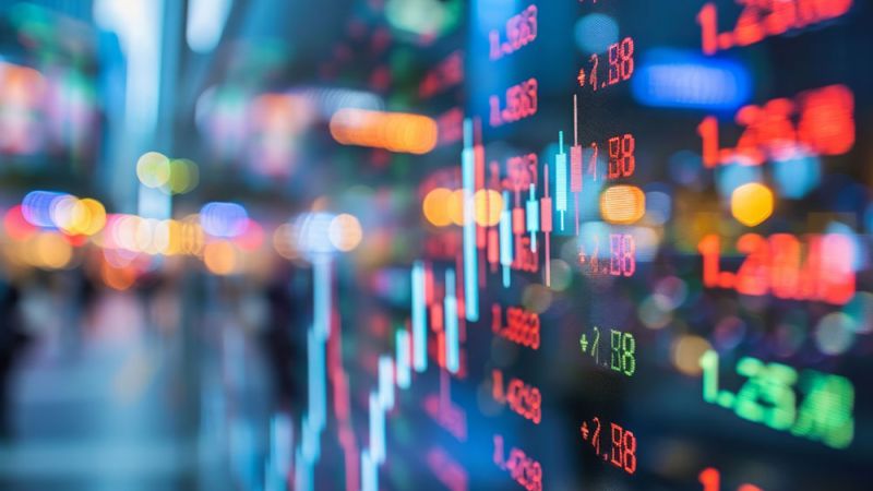 Colorful stock market graph and numbers on digital screen, illustrating financial data and trading activity.