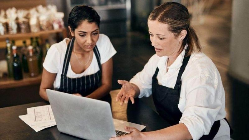 Two women working on a laptop in a New York