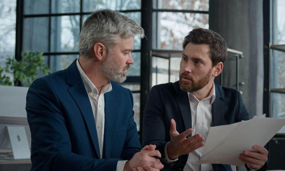 Two men discussing a business partnership dispute
