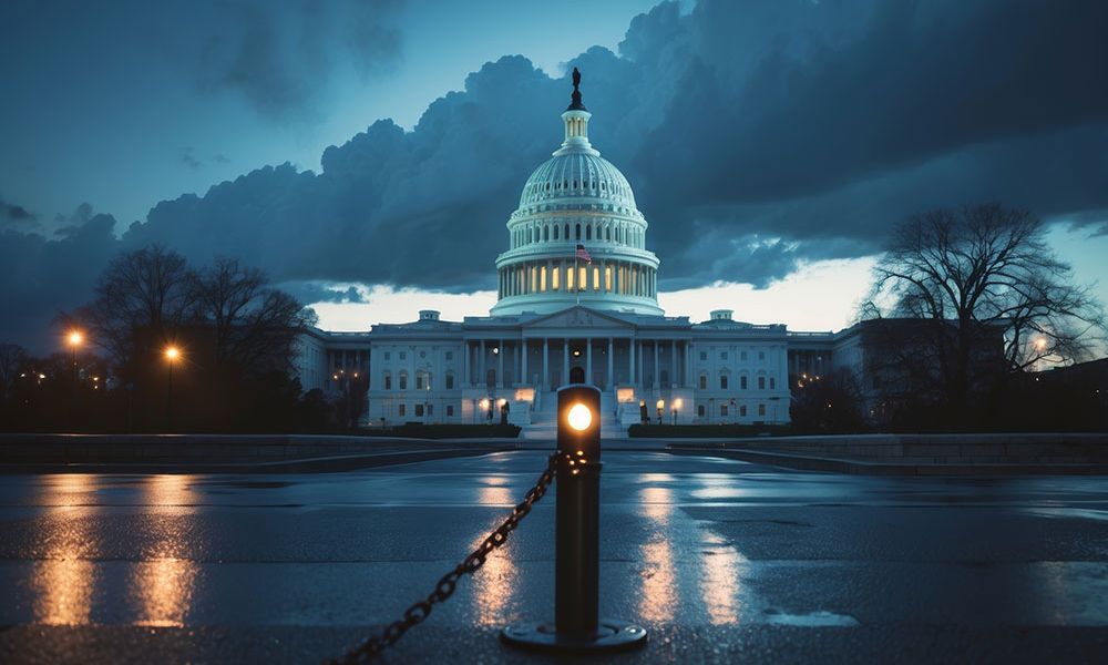 Capitol Building at dusk with dramatic clouds and streetlights illuminating the scene.