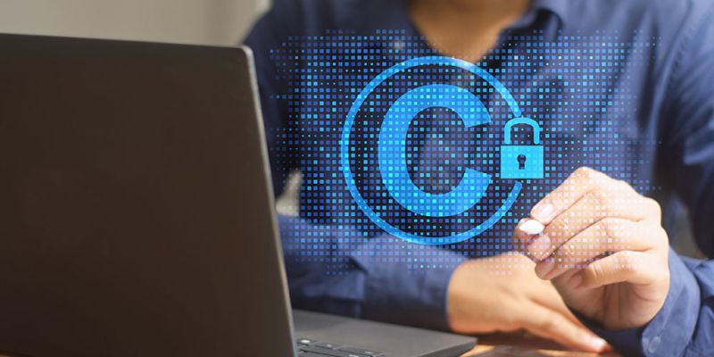 Person working on laptop with holographic copyright symbol and padlock, symbolizing digital content protection.