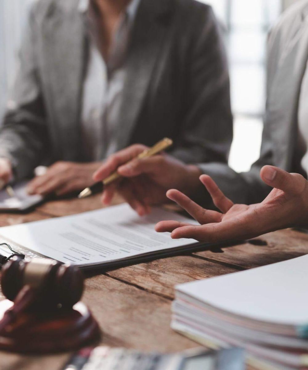 a group of people sitting around a wooden table