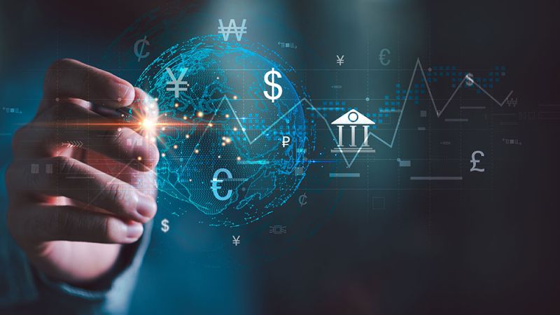 Hand interacting with digital globe, currency symbols, and financial graphs, symbolizing global finance and economy.