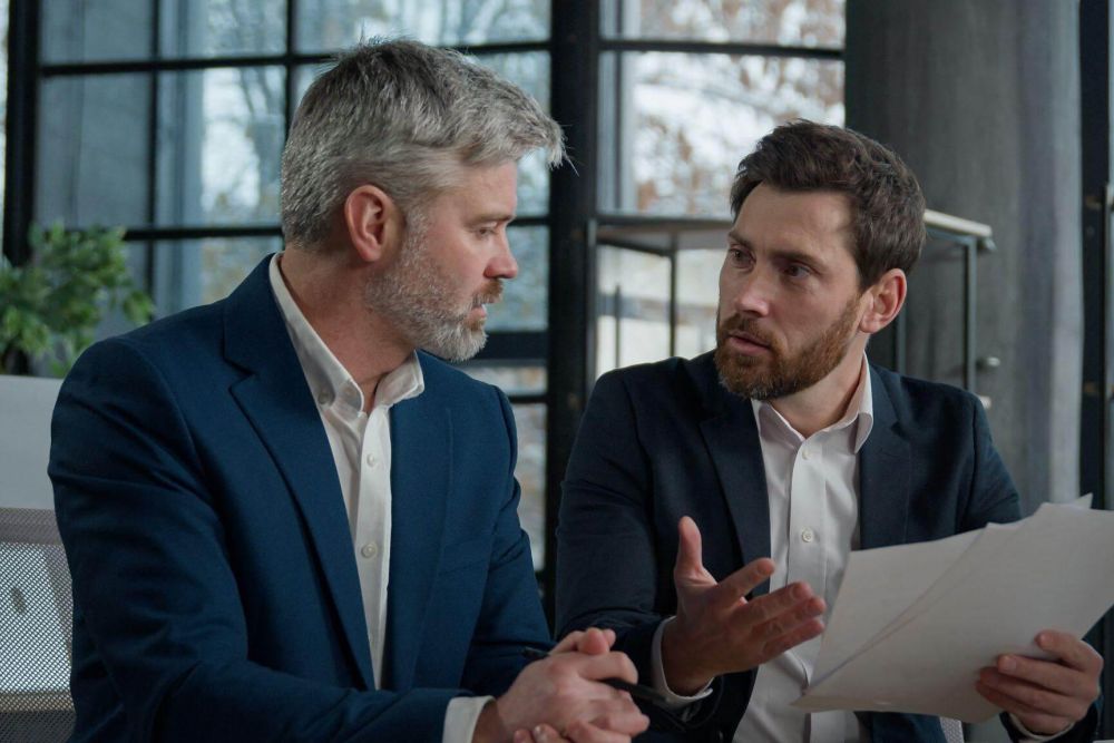 Two men discussing a business partnership dispute