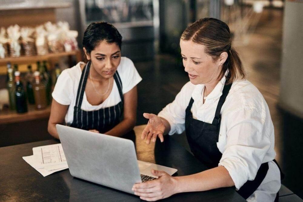 Two women working on a laptop in a New York