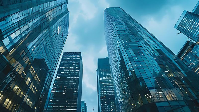 Skyscrapers rise against a cloudy sky in a modern urban landscape, emphasizing architectural grandeur and urban lifestyle.