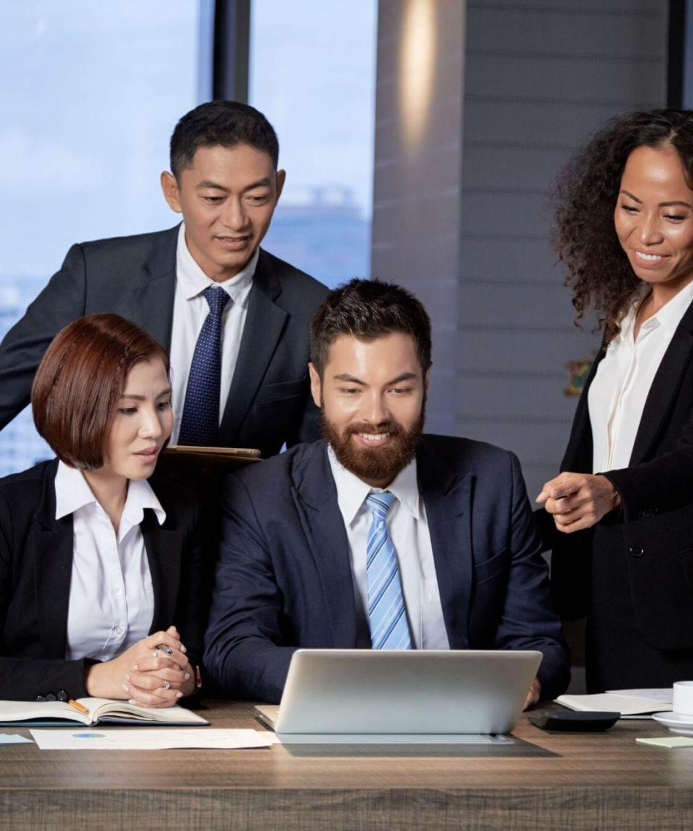 Business team reviewing laptop content