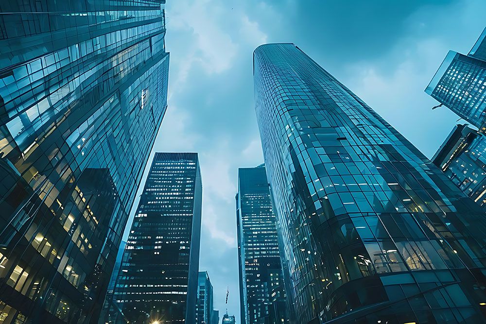 Skyscrapers rise against a cloudy sky in a modern urban landscape, emphasizing architectural grandeur and urban lifestyle.