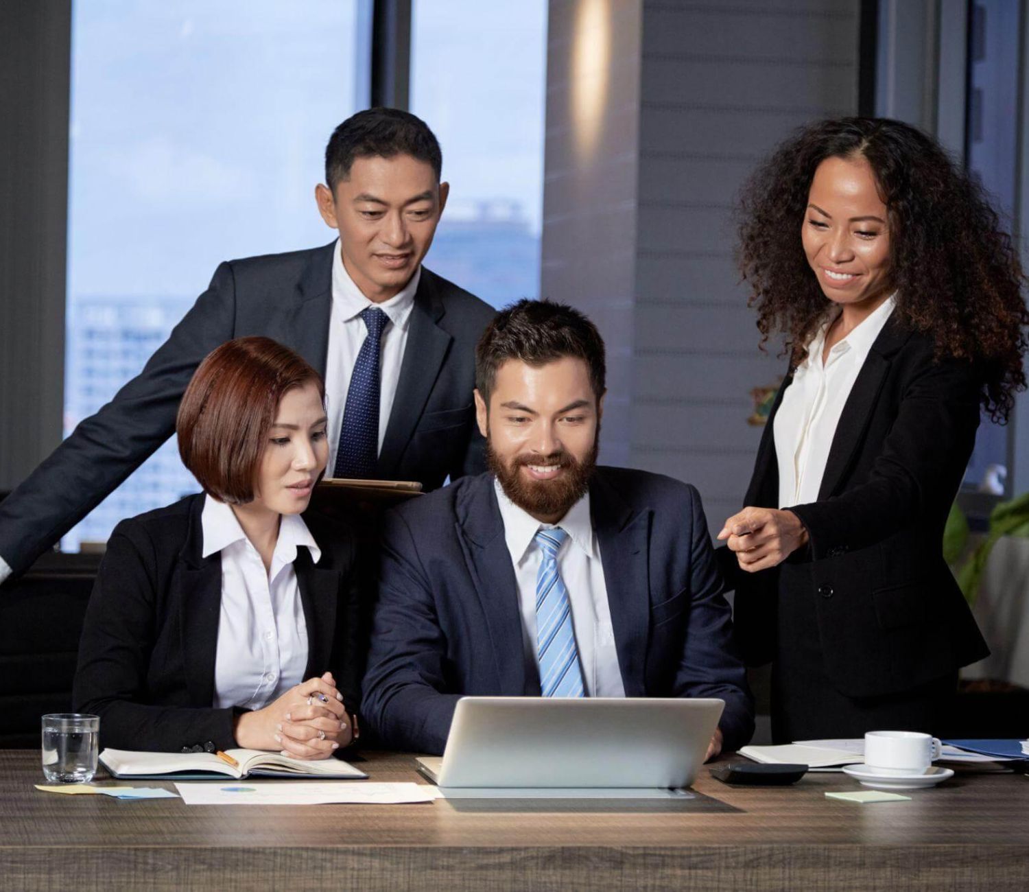 Business team reviewing laptop content