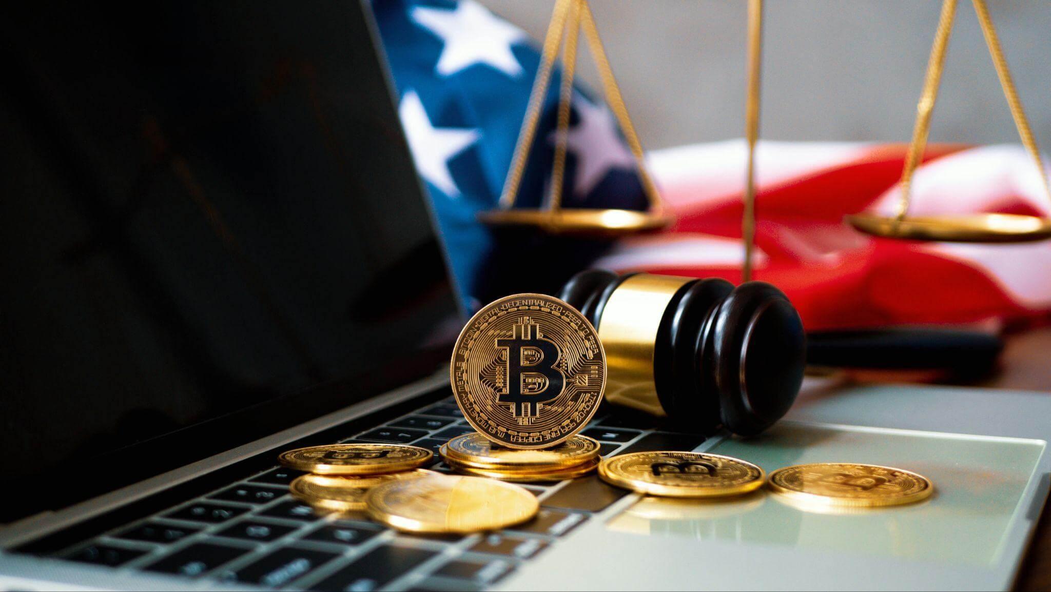 a bitcoin sitting on top of a laptop computer